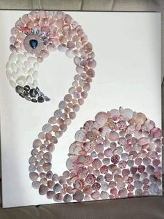 an image of a swan made out of seashells