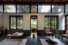 a living room filled with furniture and lots of windows