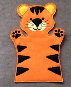 an orange tiger with black stripes on it's face and paws, sitting in the shape of a cat