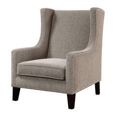 the arm chair is upholstered with studding on it's arms and legs