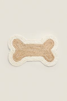 a white and brown dog bone sticker on top of a gray surface with an orange stripe