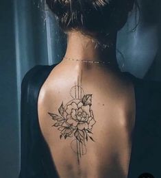 a woman with a flower tattoo on her back