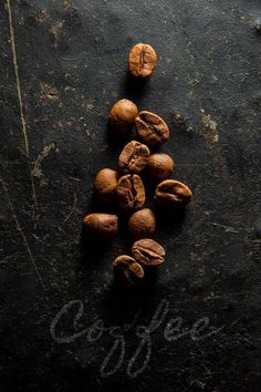 coffee beans are arranged on a black surface