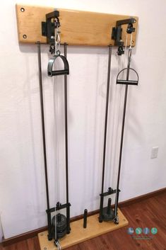 two skis are mounted to the wall with poles and hooks on them, as well as a snowboard