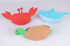 three different types of paper cut outs with sea animals and fish on top of them