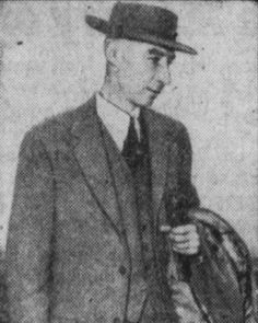 an old photo of a man in a suit and hat