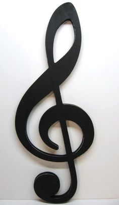 a black metal treble hanging from the side of a wall