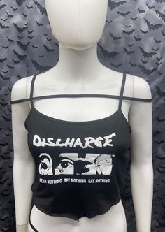 This is a black sleeveless strappy Discharge cropped tank top with a bandana style front. This has a Discharge image screen printed on the front. 91% polyester/ 9% elastane These are handmade screenprinted and slightly vary from the photo. Please feel free to email me any questions. Thanks for looking. The seller is not responsible for any lost or stolen packages. Black Rave Tops For Music Festival, Edgy Stretch Crop Top For Alternative Fashion, Black Punk Crop Top For Halloween, Black Halloween Crop Top For Streetwear, Halloween Punk Black Crop Top, Edgy Stretch Tank Top With Graphic Print, Stretch Punk Crop Top For Streetwear, Fitted Alternative Style Tank Top With Graphic Print, Black Emo Tank Top For Summer