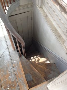 an old wooden staircase leading up to a door