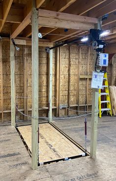 an unfinished room with wooden floors and walls