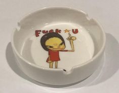 a bowl with a cartoon character painted on the side and words fuke u above it