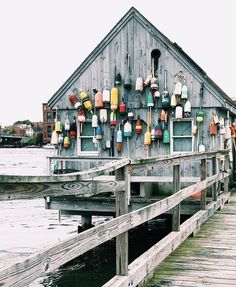 there is a boat dock that has many boats on the wall and in the water