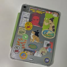 an ipad case with various stickers on it