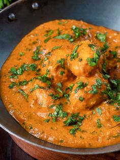 a metal pan filled with food and garnished with cilantro on top