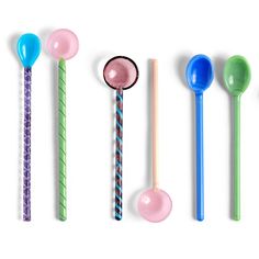 six spoons lined up in a row with different colored handles and colors on them