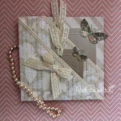 a close up of a greeting card on a table with beads and butterflies around it