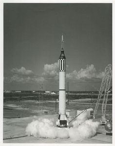 a black and white photo of a rocket launching