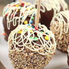 chocolate covered apples with sprinkles and candy on them are ready to be eaten