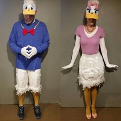 two people in costumes standing next to each other wearing donald duck hats and wigs