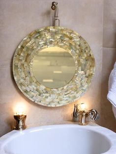 a bathroom sink with a round mirror above it