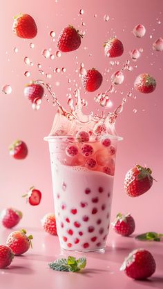 strawberries falling into a milkshake with bubbles