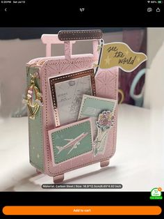 a pink suitcase with pictures and tags attached to it