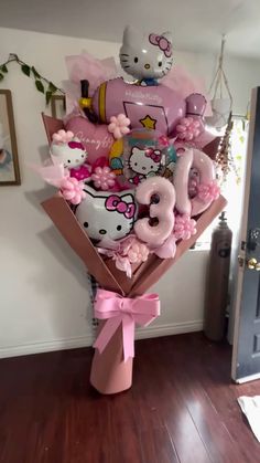 a hello kitty balloon bouquet in a room