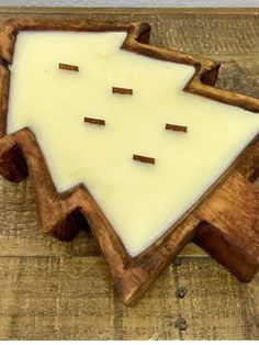 a wooden cutting board topped with a piece of cheese