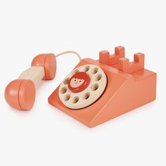 an orange phone with a red button on the front and white buttons on the back