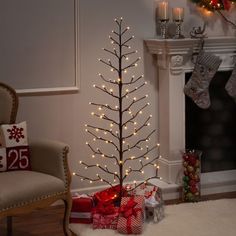 a decorated christmas tree in front of a fireplace