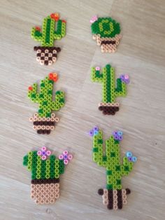 four pieces of lego art made to look like cactuses