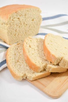 two loaves of bread sitting on top of a cutting board