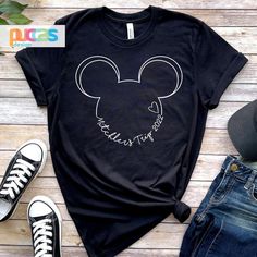 a black shirt with the words mickey mouse on it, next to jeans and sneakers