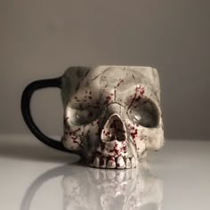 a coffee mug with blood splattered all over it's face and eyes