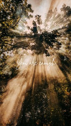 the sun shining through trees with an inscription on it that reads, you are enough