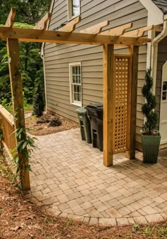 an outdoor patio with a pergolan and trash can