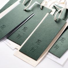 four green tags with chinese writing on them