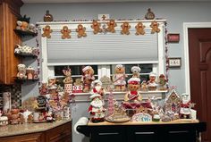 a kitchen decorated for christmas with gingerbreads and cookies on the window sill