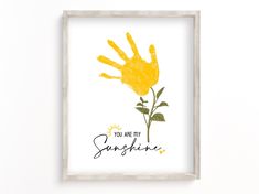 a yellow handprint with the words you are my sunshine on it in front of a white wall