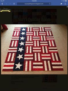 an american flag quilt is displayed on the floor in front of a laptop computer screen