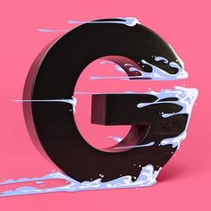 the letter g is painted black and white with paint splatters on it's sides