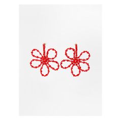 two red beaded flowers on white background