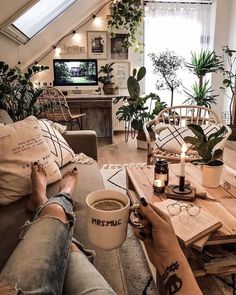 a person sitting on a couch with their feet up in front of a coffee cup