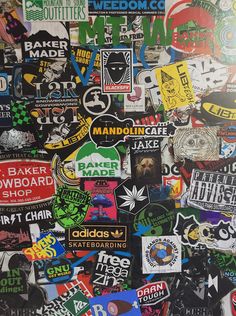 a wall covered in lots of different types of stickers