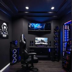 a gaming room with black walls and blue lights