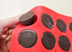 a person is holding a chocolate tray with oreos in it