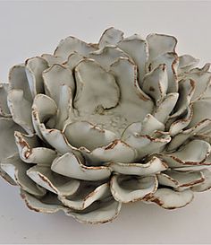 a large white flower sitting on top of a table