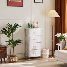 a living room filled with white furniture and lots of flowers on top of a table