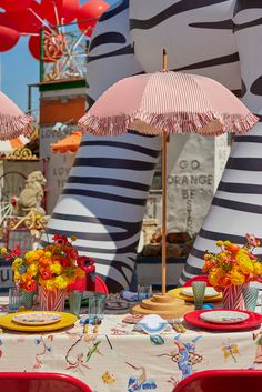 a table with two umbrellas and plates on it