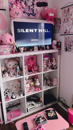 a living room filled with lots of stuffed animals and toys on top of a white book shelf